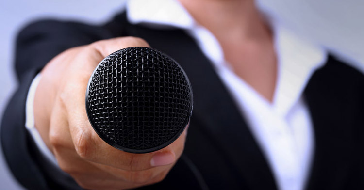 Man holding out a microphone to record what you say