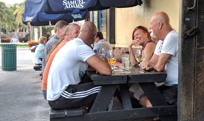 people in conversation outside bar