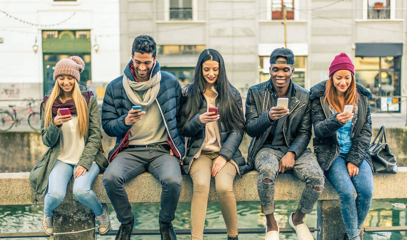 Row of people on their smartphones