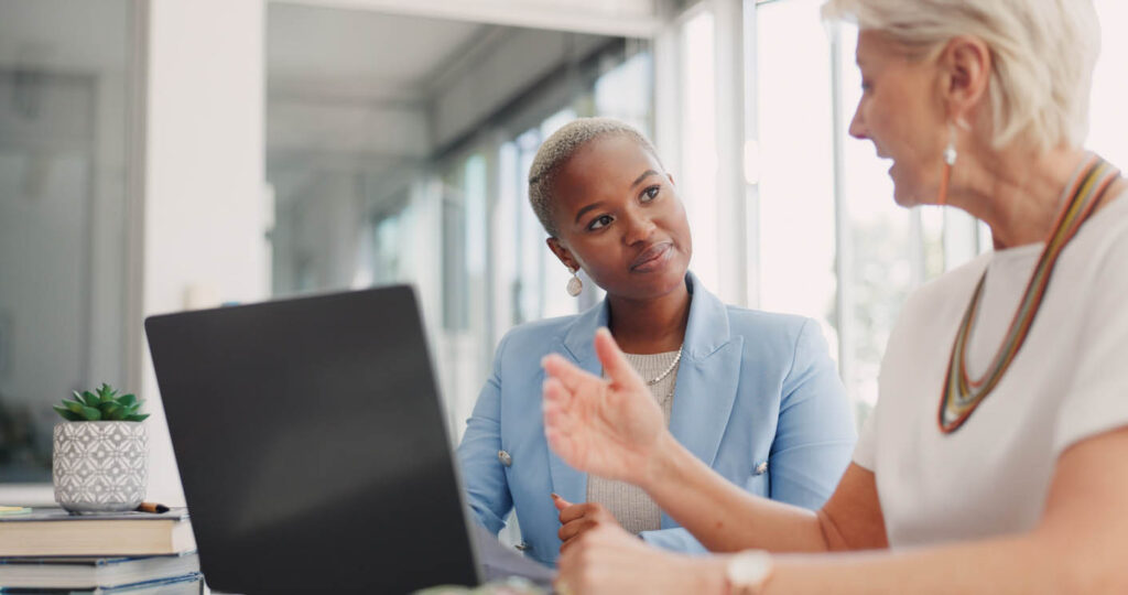 Two female colleagues in conversation about SEO